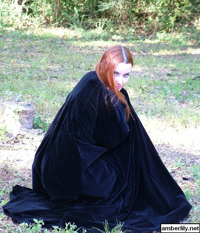 Redhead amateur Amber Lily models nude in a forest draped in a black cape - #6