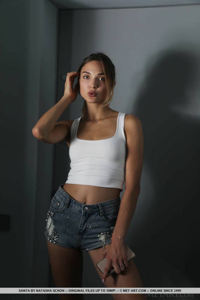 Beautiful teen Santa doffs a tank top and cutoff shorts to model in the nude - #13