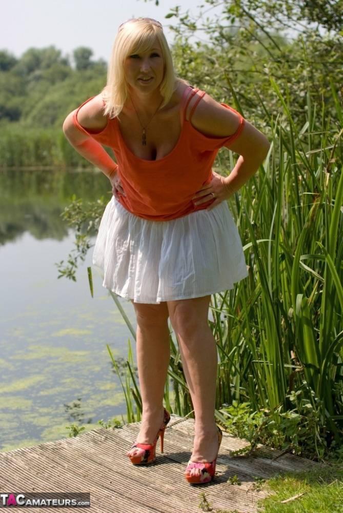 Fat blonde woman with large breasts Melody gets undressed on lakeside dock - #14