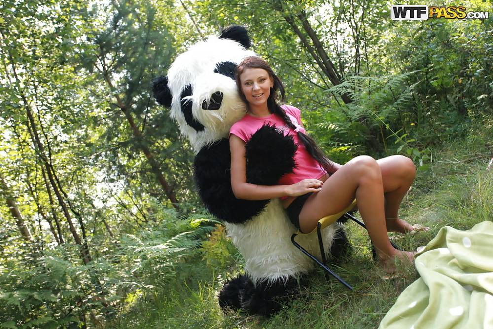 Naughty teen cutie with svelte body have some fun with a panda toy outdoor - #2