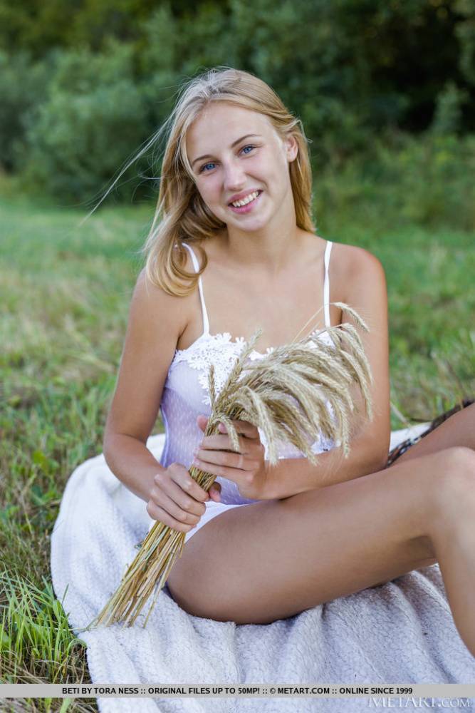 Young blonde Beti gets totally naked while having a picnic in a hay field - #7