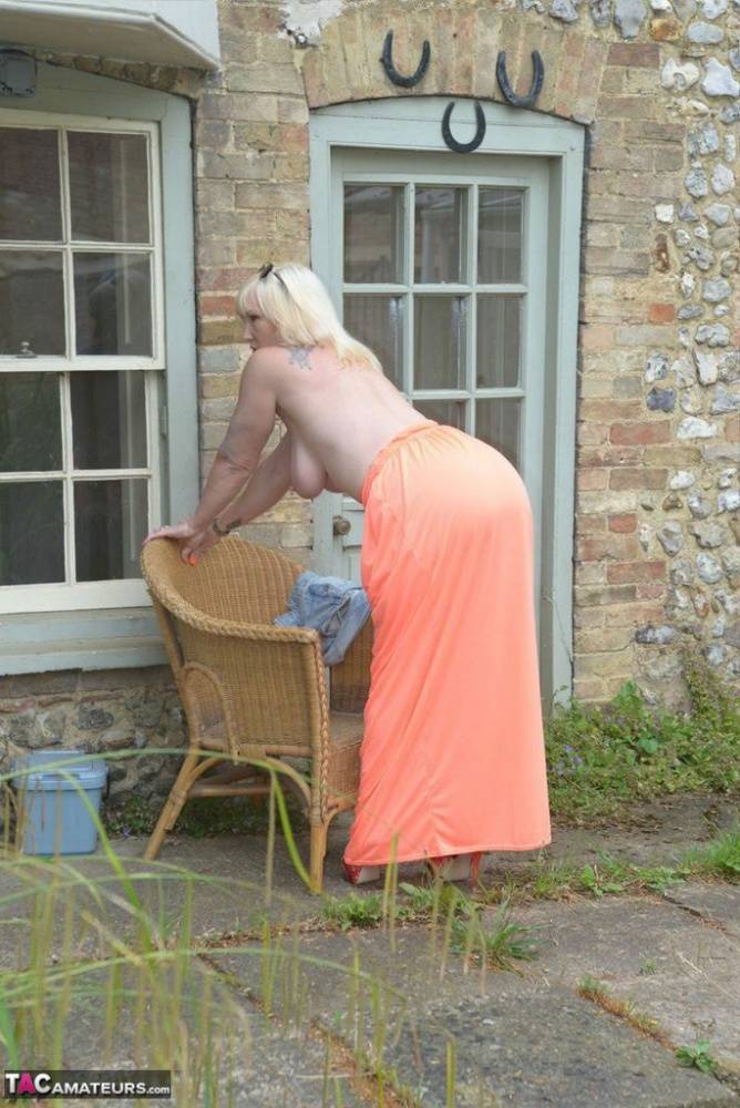 Big titted blonde Melody drops her dress outside to air her naked mature tits - #1