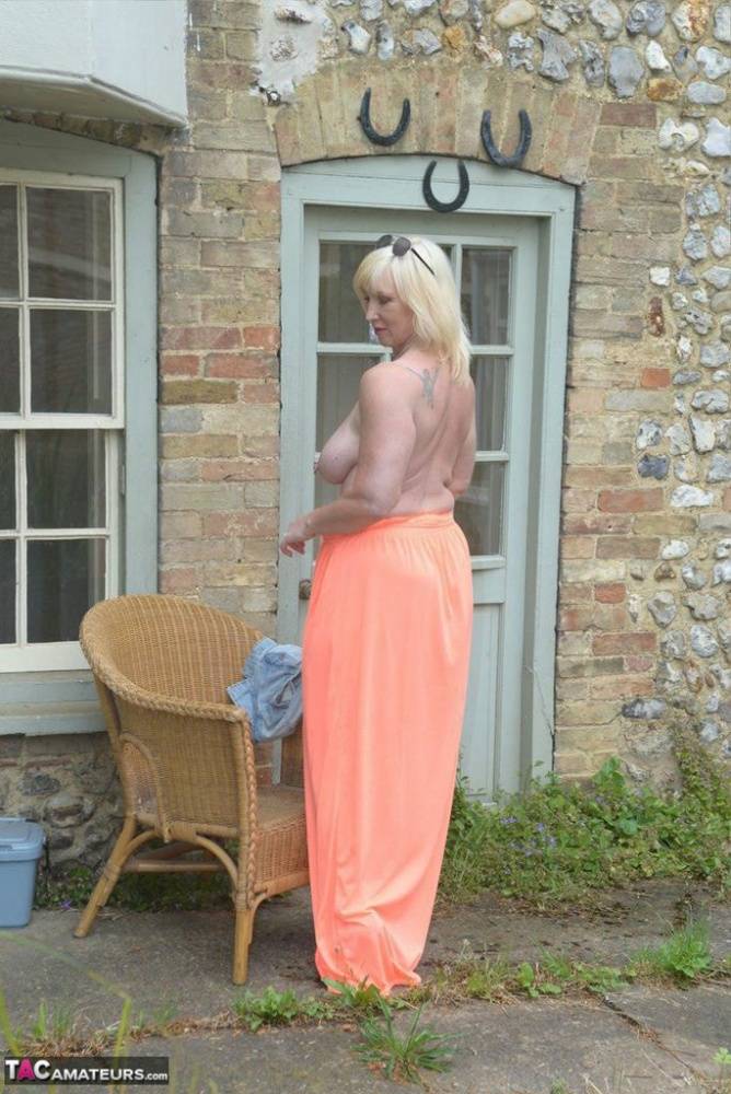 Big titted blonde Melody drops her dress outside to air her naked mature tits - #10
