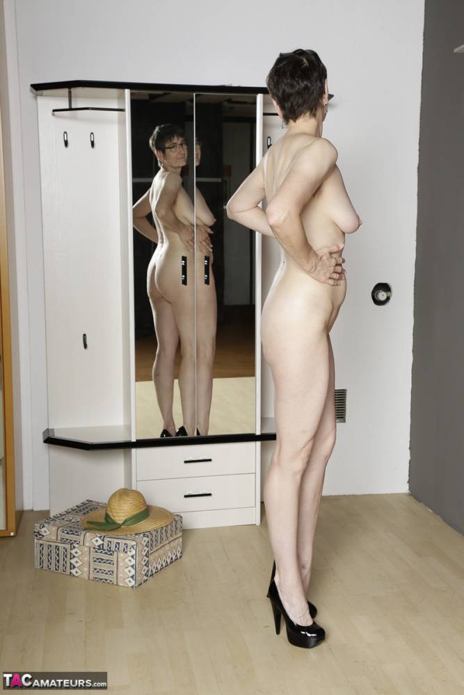 Mature amateur admires her naked body in a mirror while wearing black heels - #15
