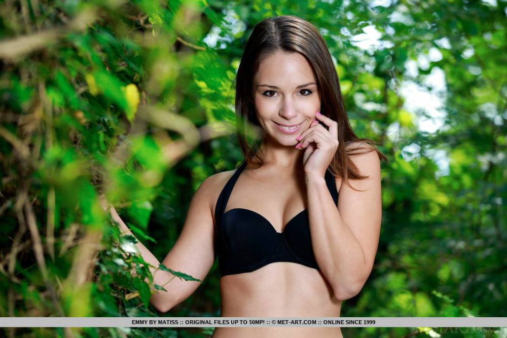 Young beauty Emmy exposes her tight body while in a forest - #10
