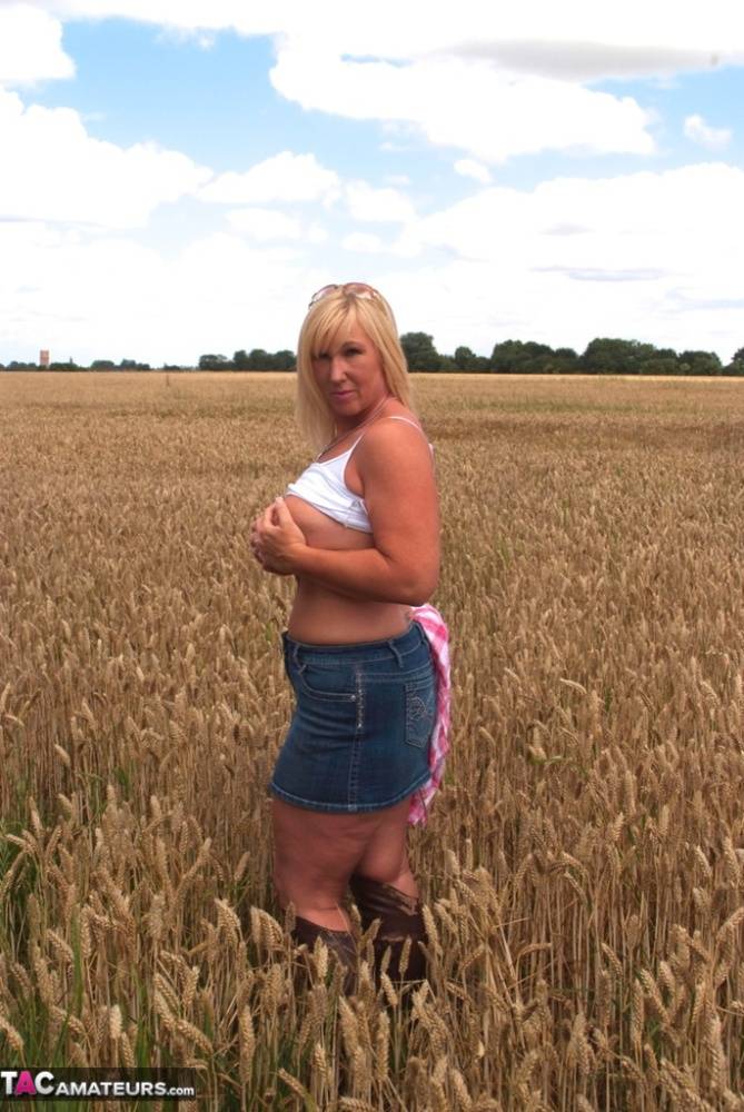 Chubby mature MILF Melody reveals great big tits & flashes hot ass in a field - #12
