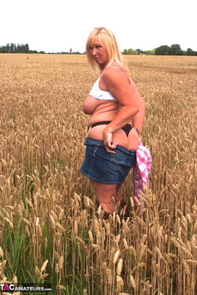 Chubby mature MILF Melody reveals great big tits & flashes hot ass in a field - #13