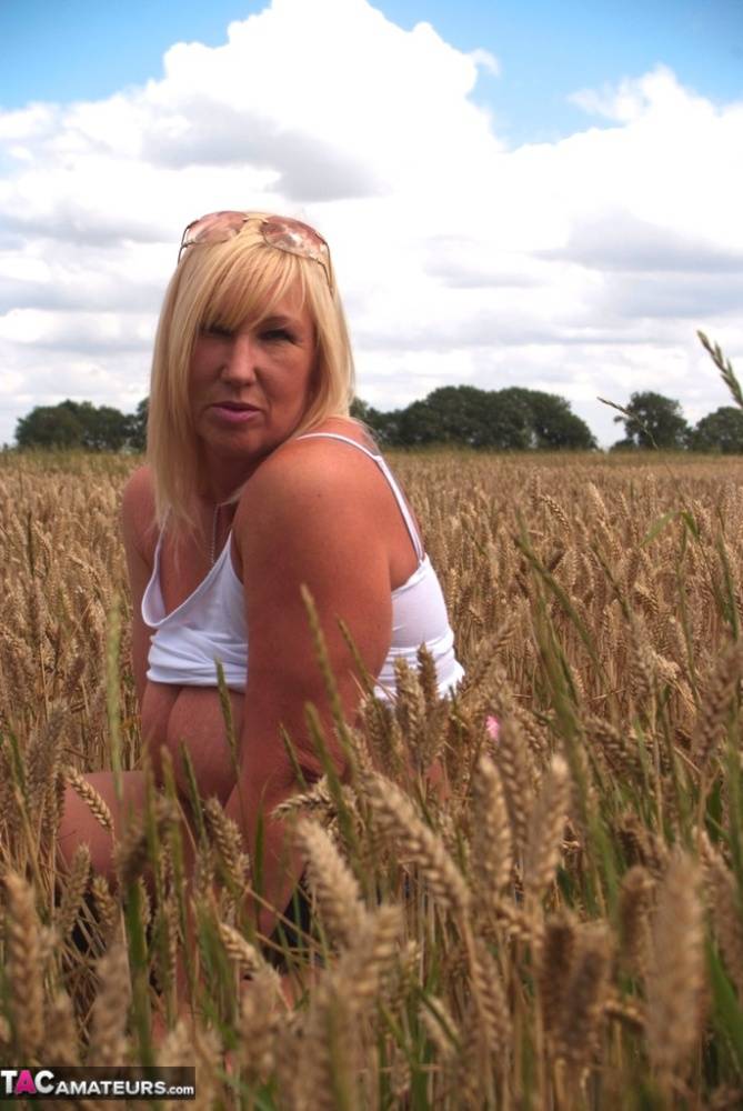 Chubby mature MILF Melody reveals great big tits & flashes hot ass in a field - #14