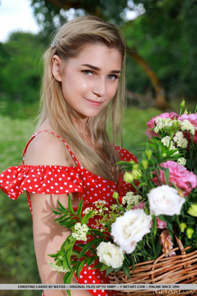 Young blonde Christine Cardo gets naked in a hilly field while picking flowers - #1