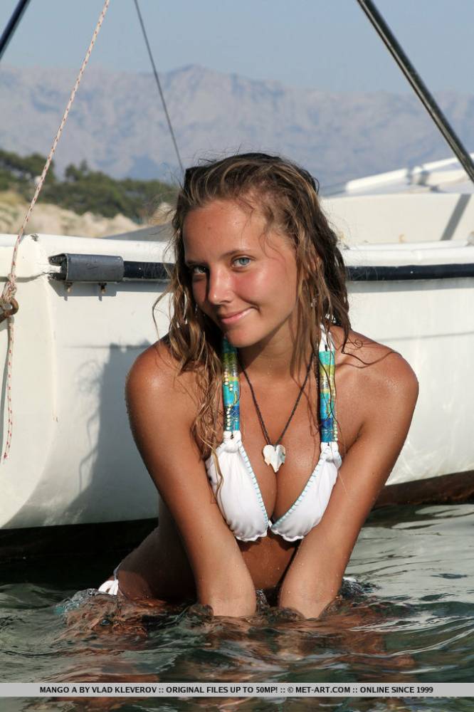 Cute teen Mango A doffs bikini on boat to show tiny tits and bald pussy - #13