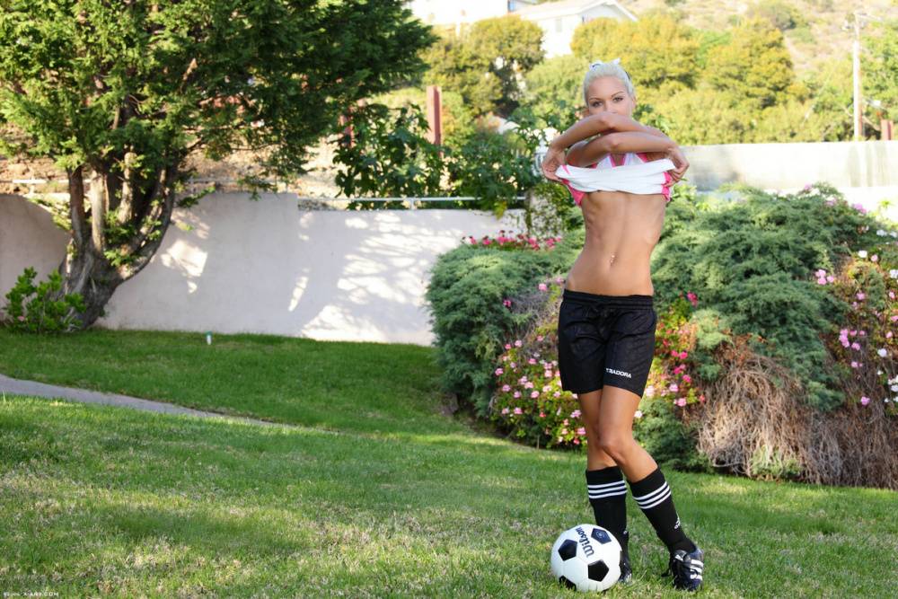 Skinny blonde girl uncovers tiny tits while bouncing a soccer ball outdoors - #12