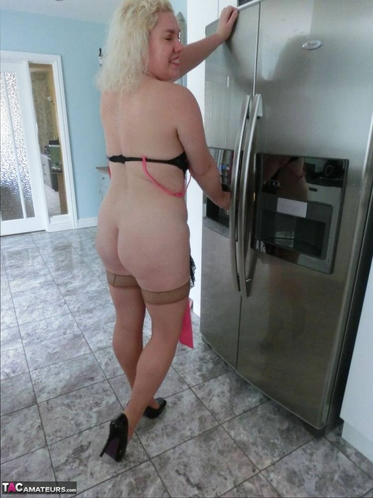 Aged blonde Barby removes lingerie to get naked in tan stockings while cooking - #12