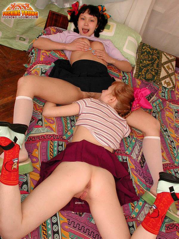 Barely legal dykes share a double ended dildo on their shared bed - #8