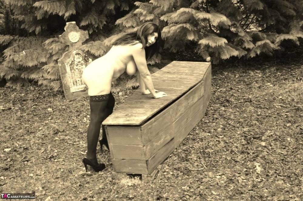 Goth girl Barby Slut bares her big tits and twat atop a casket in the woods - #11