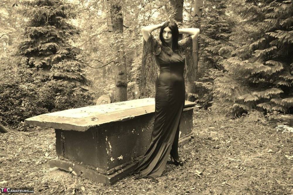 Goth girl Barby Slut bares her big tits and twat atop a casket in the woods - #5