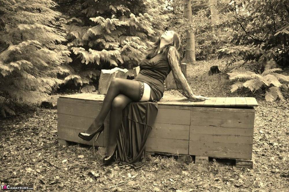 Goth girl Barby Slut bares her big tits and twat atop a casket in the woods - #7