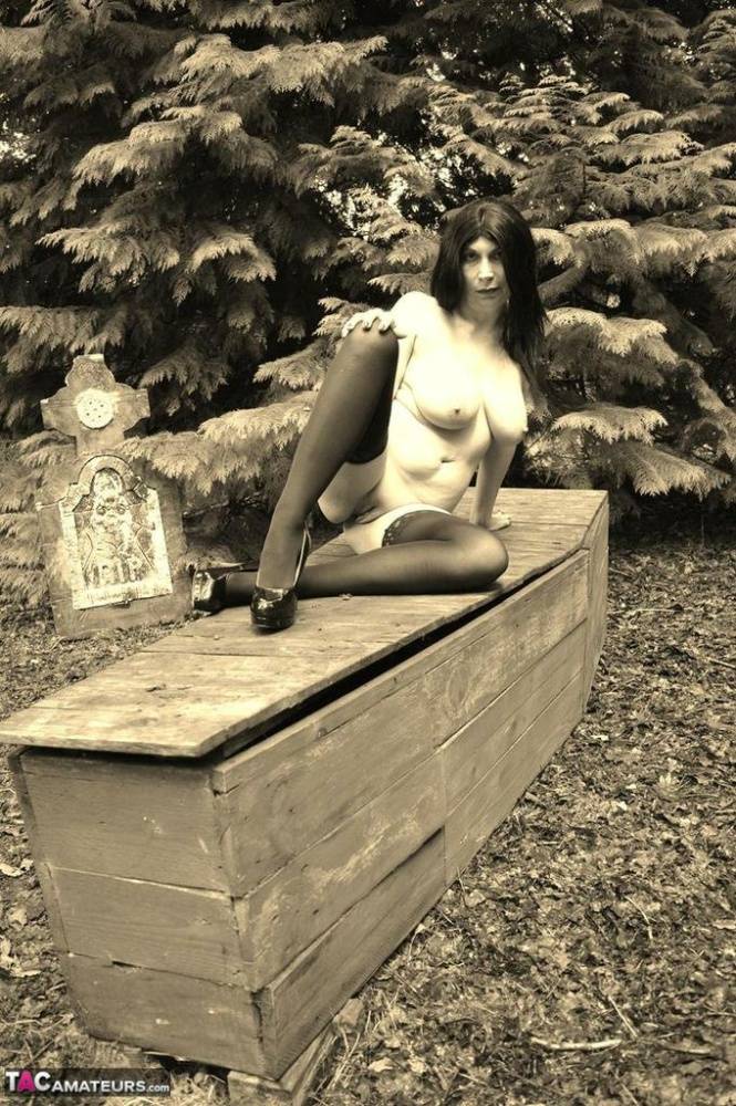 Goth girl Barby Slut bares her big tits and twat atop a casket in the woods - #15