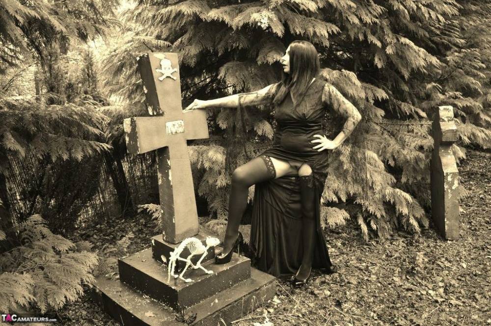 Goth girl Barby Slut bares her big tits and twat atop a casket in the woods - #12
