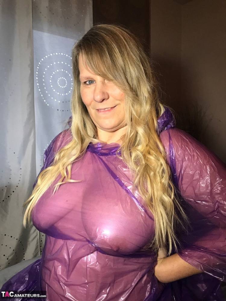 Mature amateur Sweet Susi lifts up a see-through raincoat to show her snatch - #16