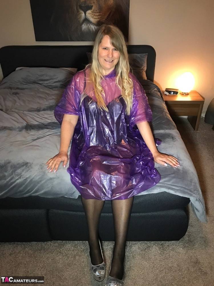 Mature amateur Sweet Susi lifts up a see-through raincoat to show her snatch - #13