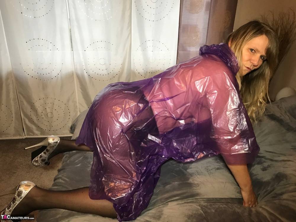 Mature amateur Sweet Susi lifts up a see-through raincoat to show her snatch - #11
