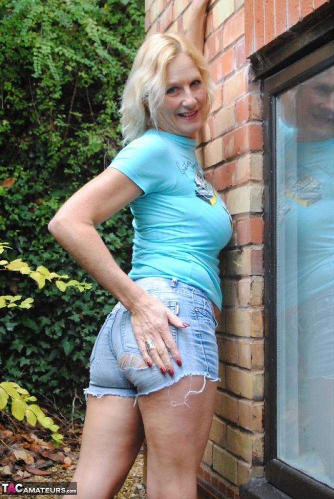Cute mature MILF Molly sheds shorts in the yard to pose in hot thong panties - #2