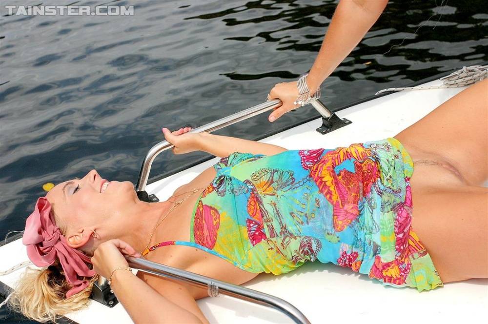 Clothed blondes hike up their dresses before being peed upon on a boat - #13