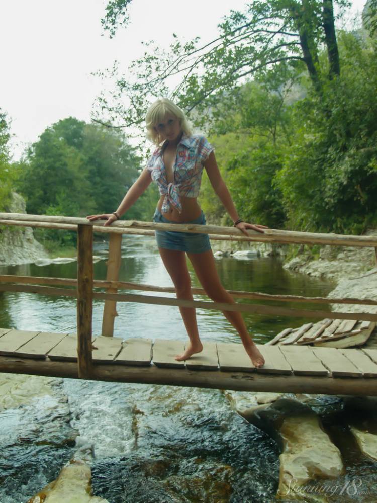 18-year-old blonde Nellie Y gets bare naked on a footbridge across a stream - #12