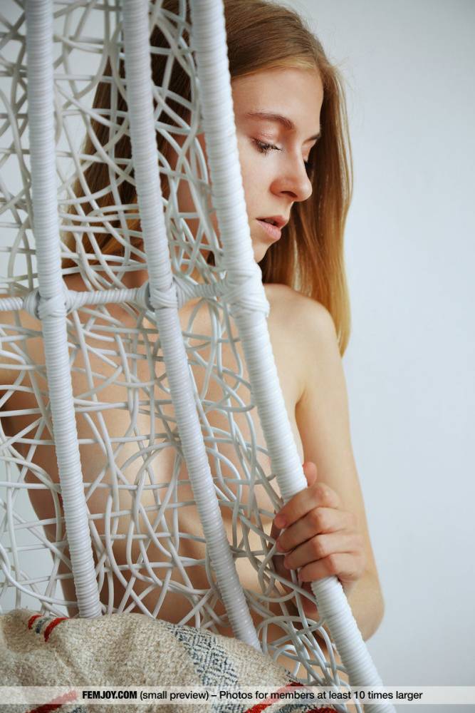 Young looking girl displays her bald pussy in a hanging basket chair - #4