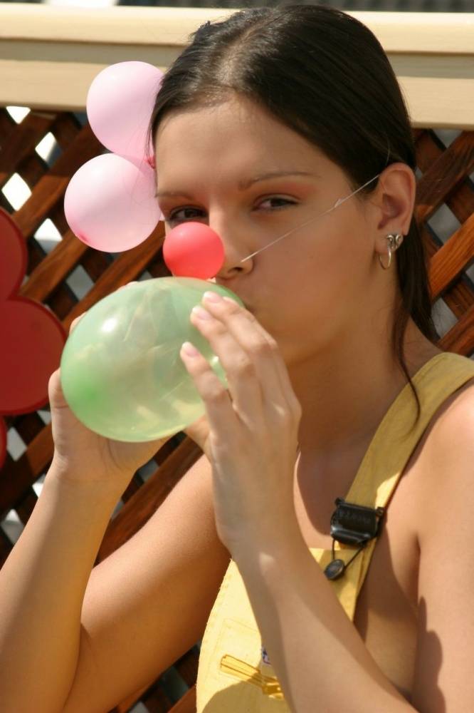 Beautiful girl Sweet Eva gets naked while blowing up balloons on a patio - #6