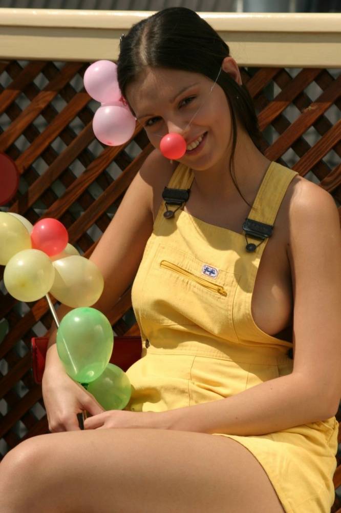 Beautiful girl Sweet Eva gets naked while blowing up balloons on a patio - #10