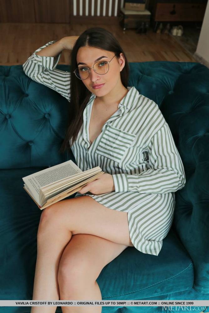 Young brunette Vavilia Cristoff reads a book on a sofa before getting naked - #2