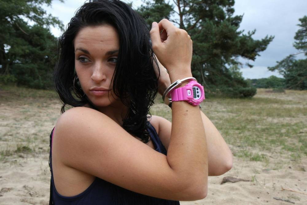 Brunette girl Nora is handcuffed to a tree while wearing a pink G-Shock watch - #15