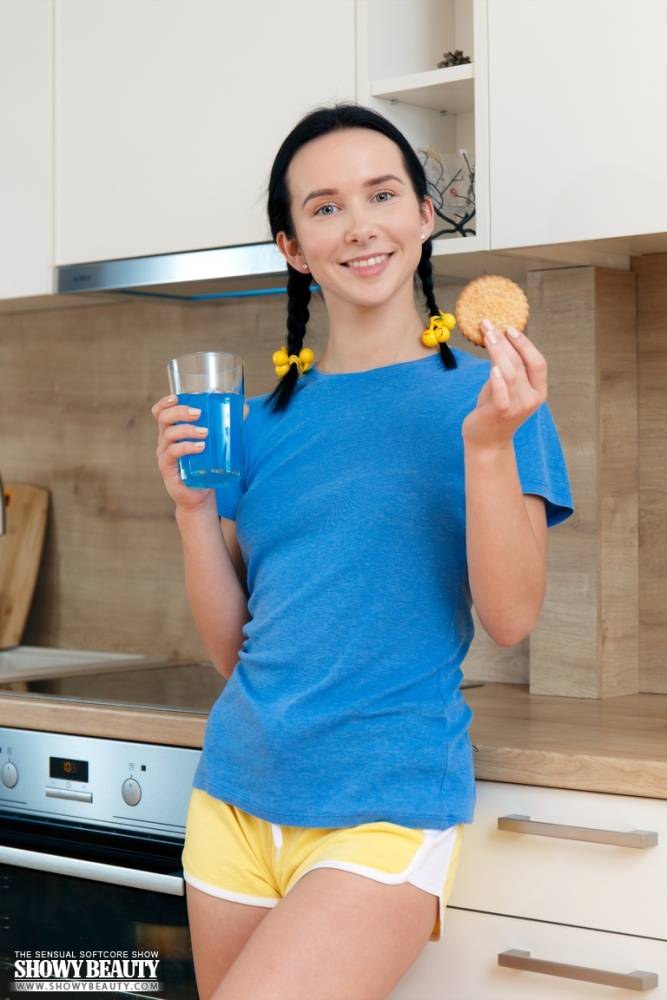 Young looking girl Natasha eats a cookie while getting naked in the kitchen - #7