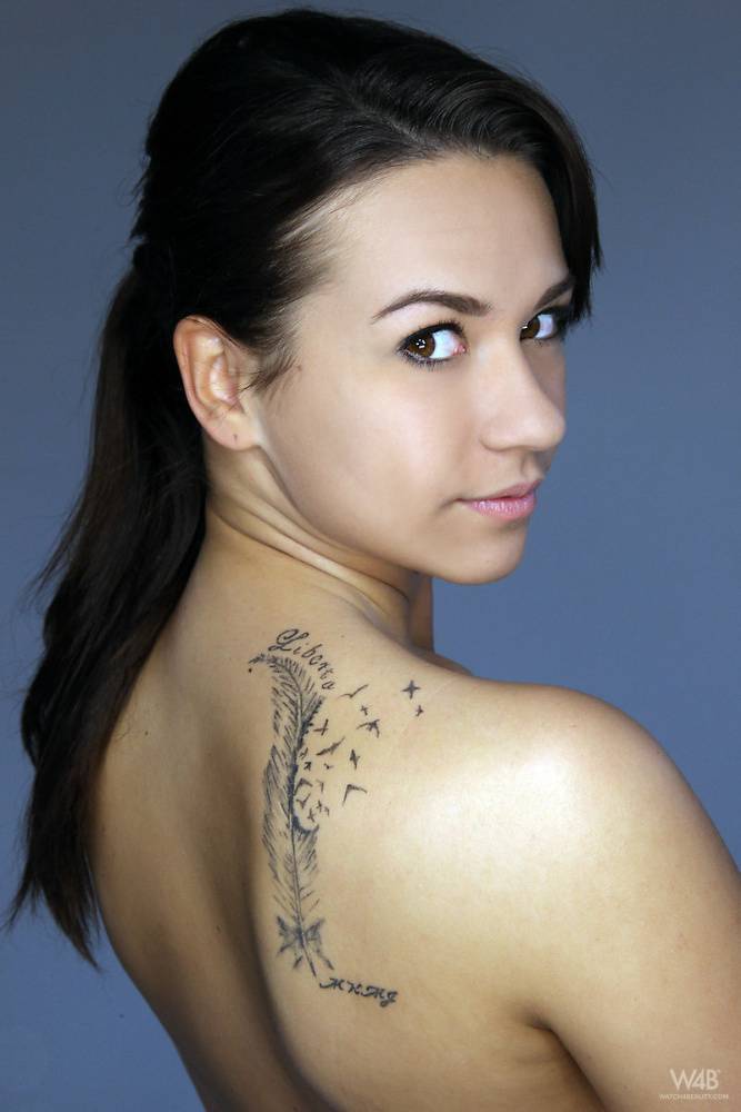 Solo girl with dark hair and a tattoo on her shoulder blade models in the nude - #8