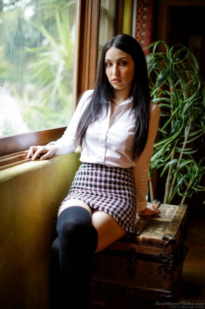 Dark haired girl strips to black over the knee socks in front of a window - #9