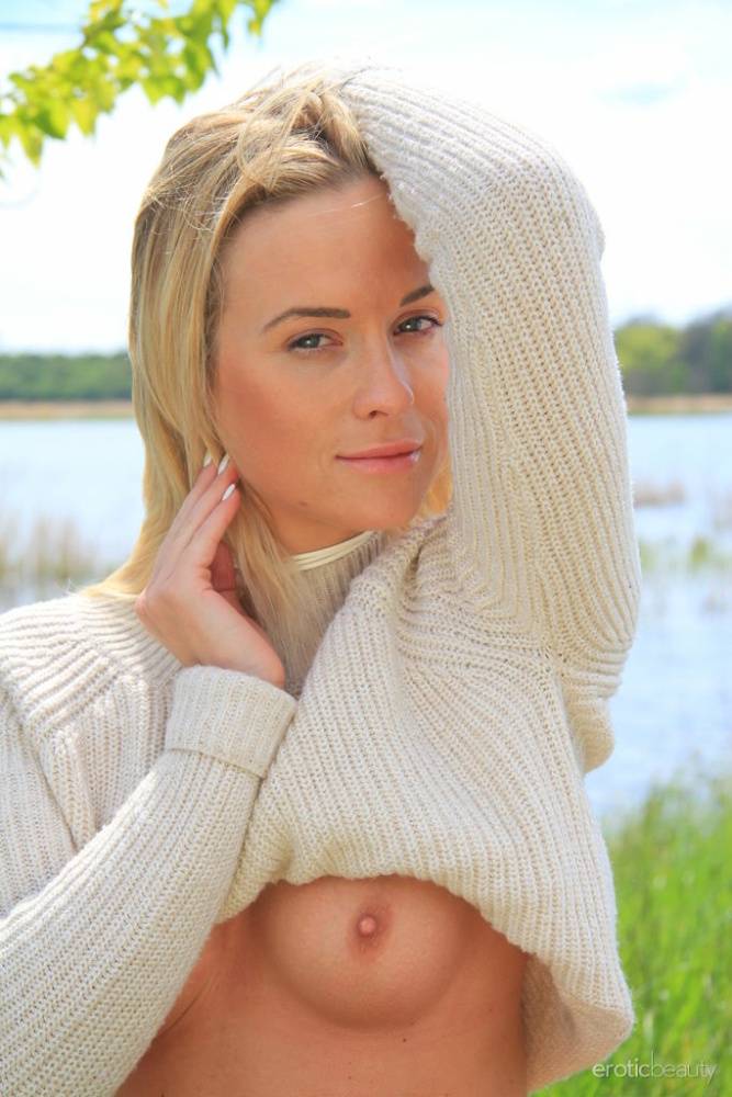 Young blonde Cristal Caitlin lifts up her sweater while bottomless by a river - #12