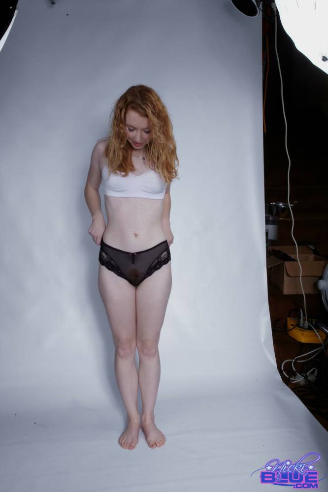 Natural redhead Nicki Blue pulls down her black panties during a solo shoot - #7