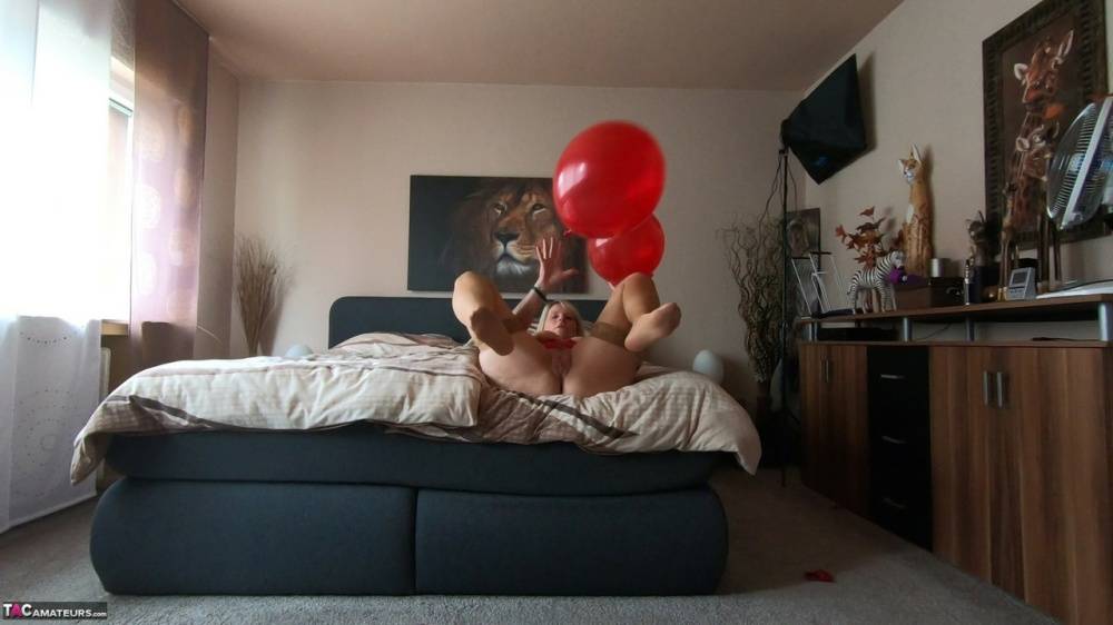 Middle-aged blonde Sweet Susi exposes her tits while playing with balloons - #13