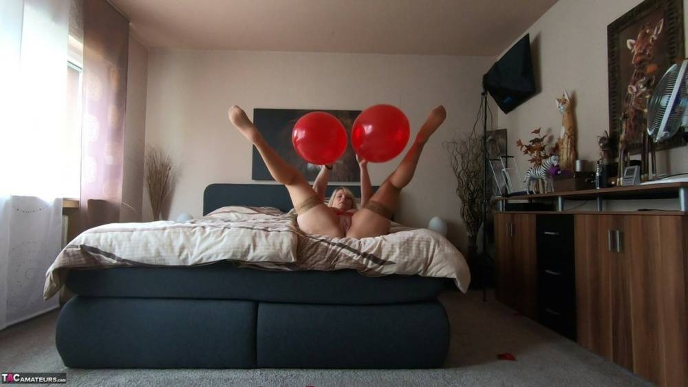 Middle-aged blonde Sweet Susi exposes her tits while playing with balloons - #6