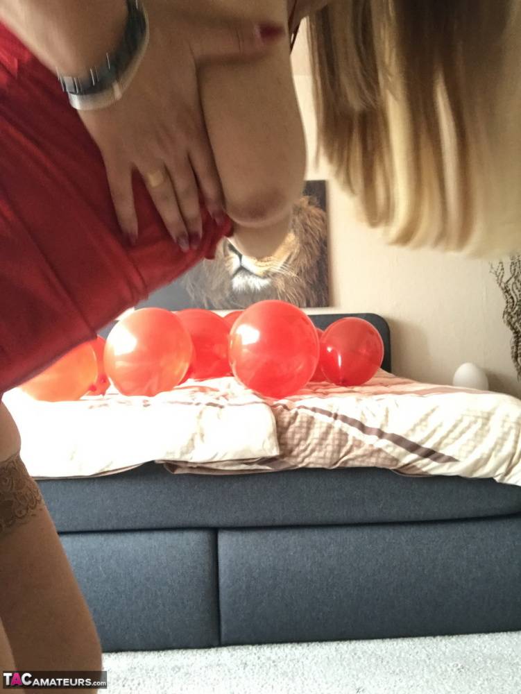 Middle-aged blonde Sweet Susi exposes her tits while playing with balloons - #15