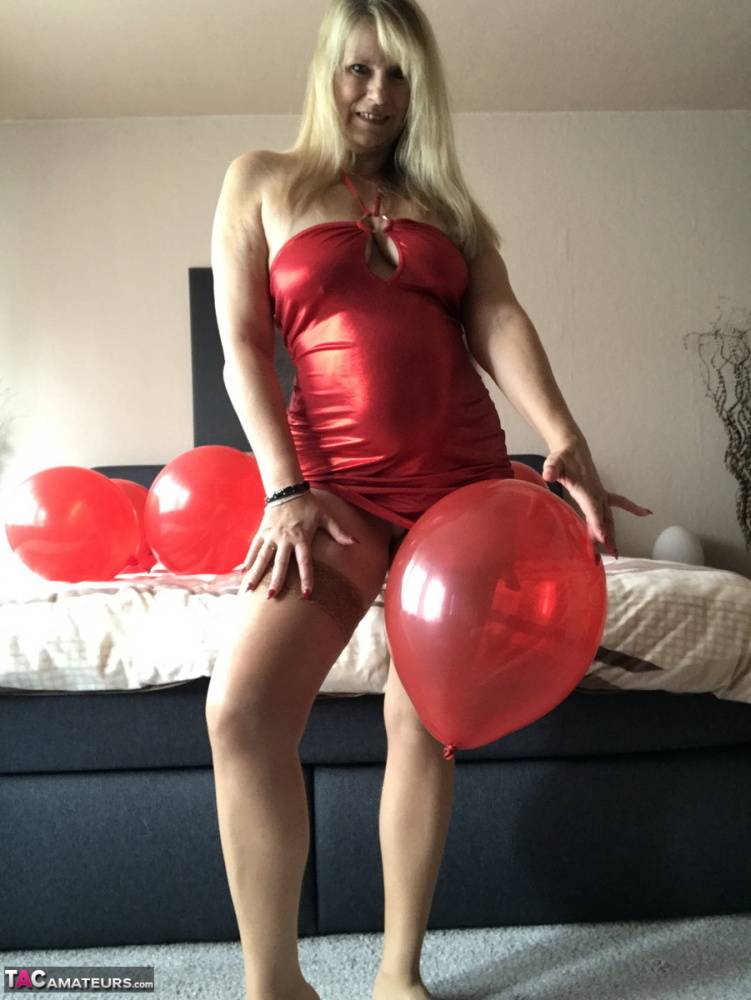 Middle-aged blonde Sweet Susi exposes her tits while playing with balloons - #10