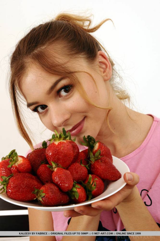 Charming teen Kaleesy gets totally naked with a plate of strawberries at hand - #1