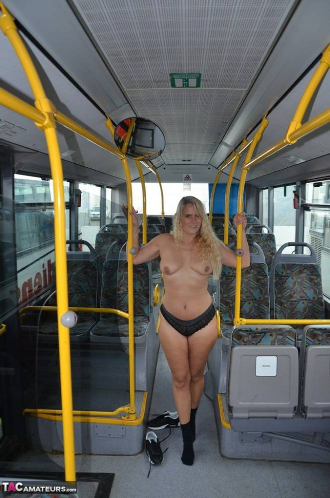 Thick blond chick takes off her underwear to pose naked in socks on a city bus - #9