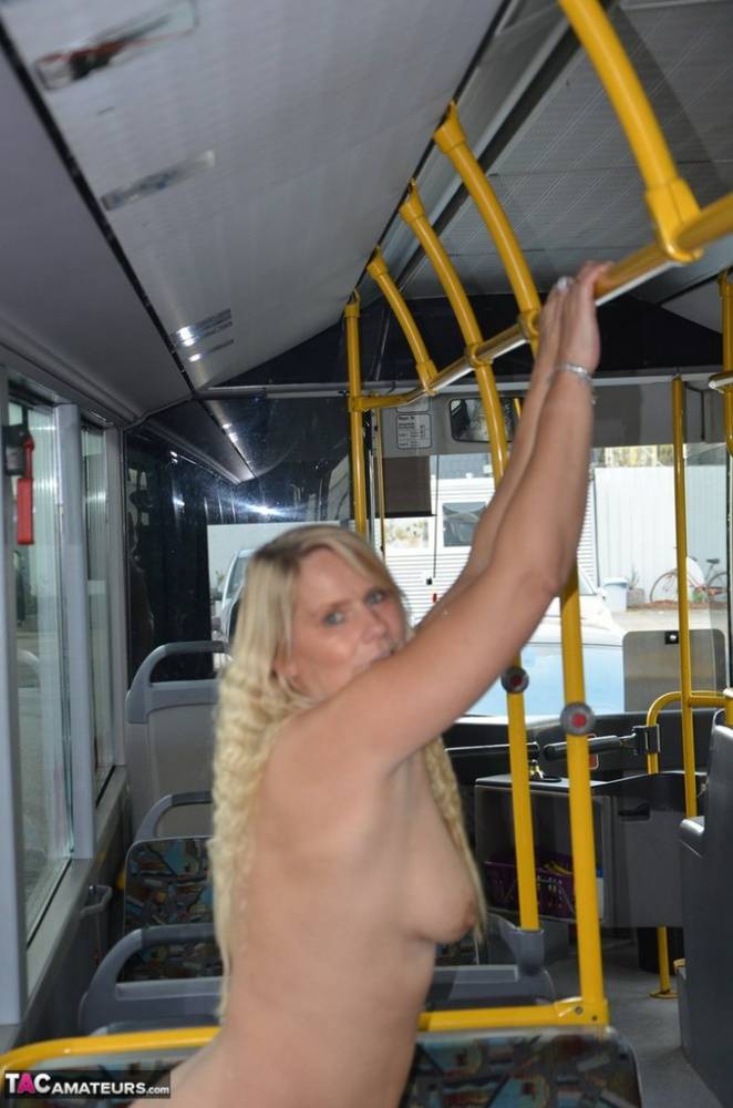 Thick blond chick takes off her underwear to pose naked in socks on a city bus - #15