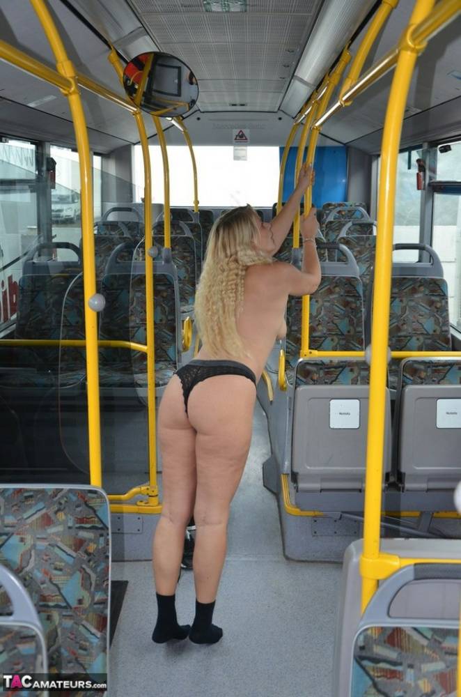 Thick blond chick takes off her underwear to pose naked in socks on a city bus - #11