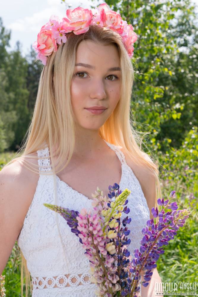 Young blonde wears a crown of flowers during her nude debut amid fireweed - #16