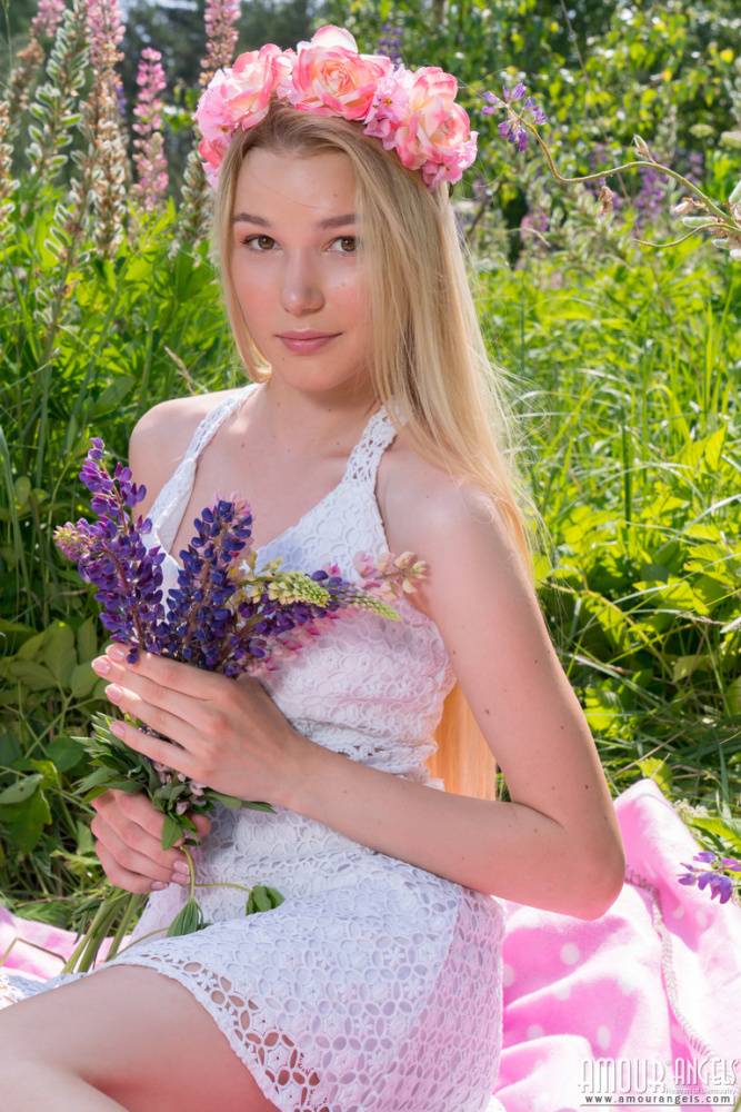 Young blonde wears a crown of flowers during her nude debut amid fireweed - #9