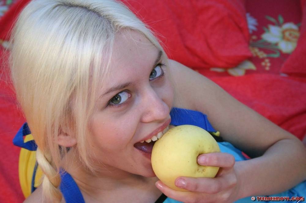 Young looking blonde eats a banana during close-up fucking on a bed - #15