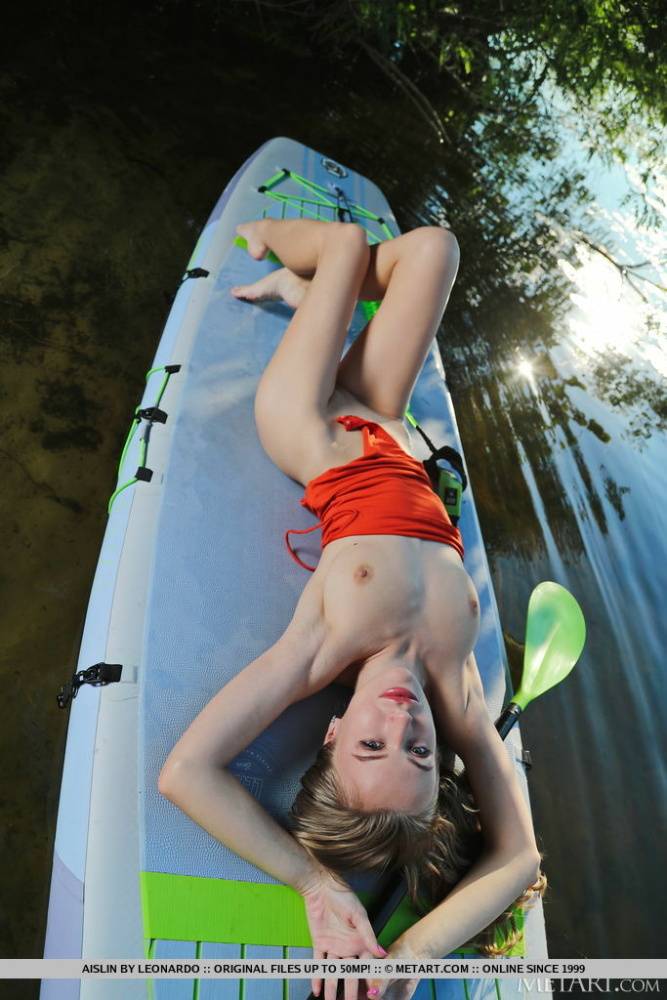 Skinny teen Aislin takes off her swimsuit to pose nude on a kayak - #12
